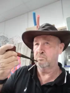 a pipe and a kangaroo skin hat